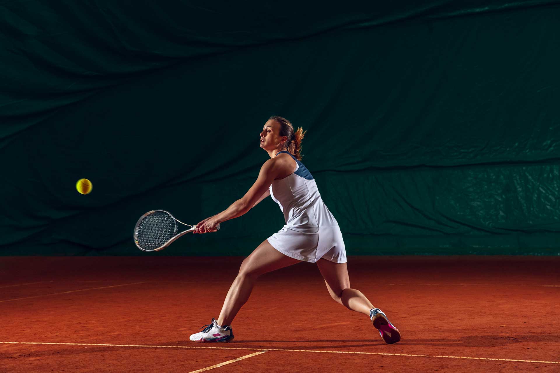 Young man preparing healthy food and peeling avocado in the kitchen.